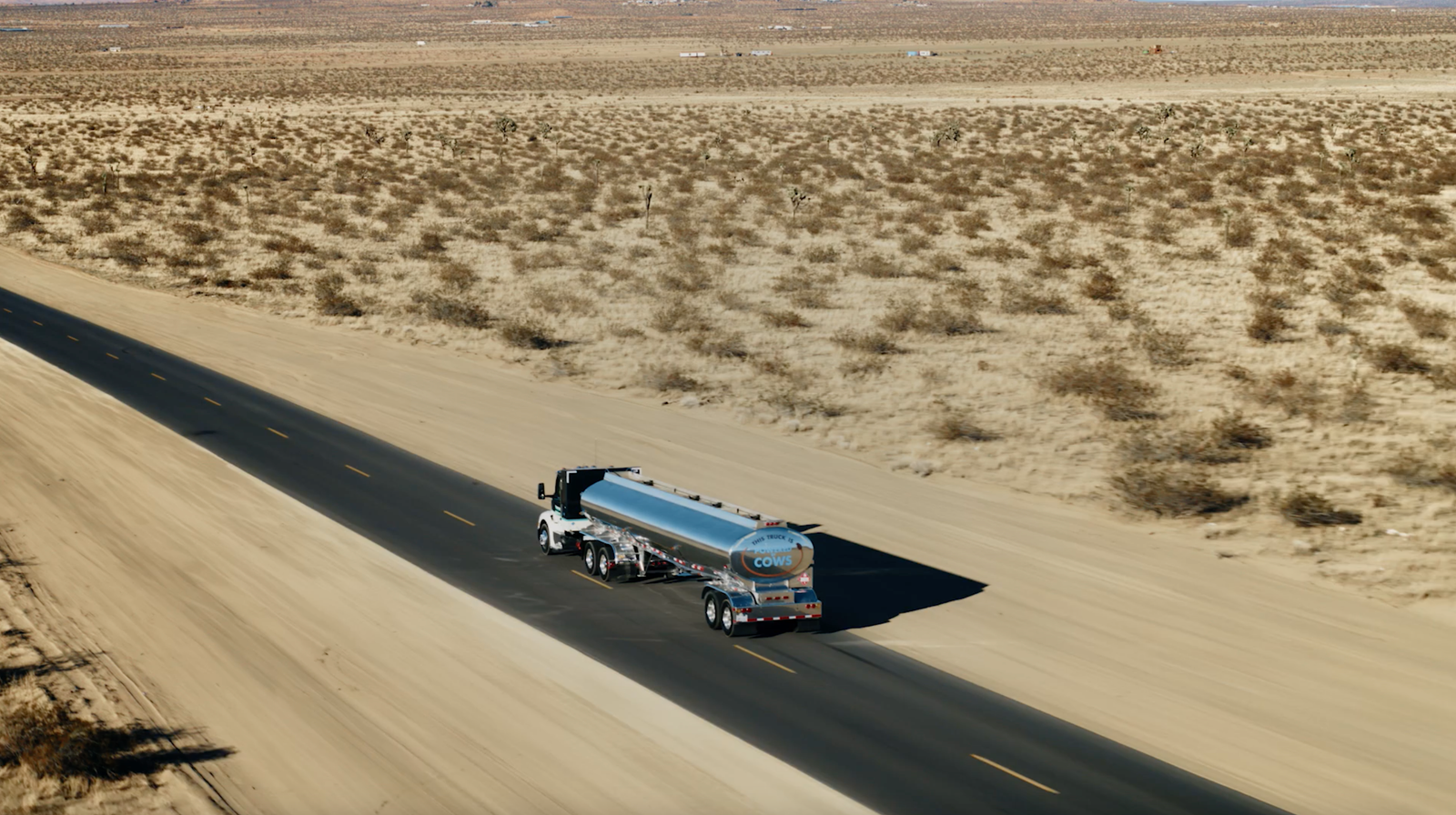 A tanker truck running an open desert highway
