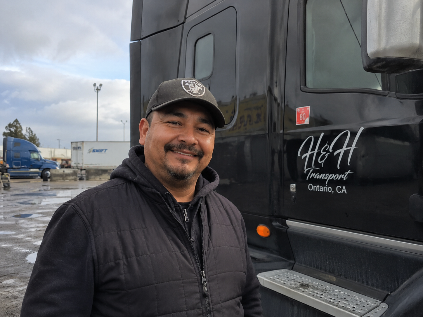 A carrier who runs freight on Tandem, standing by his truck